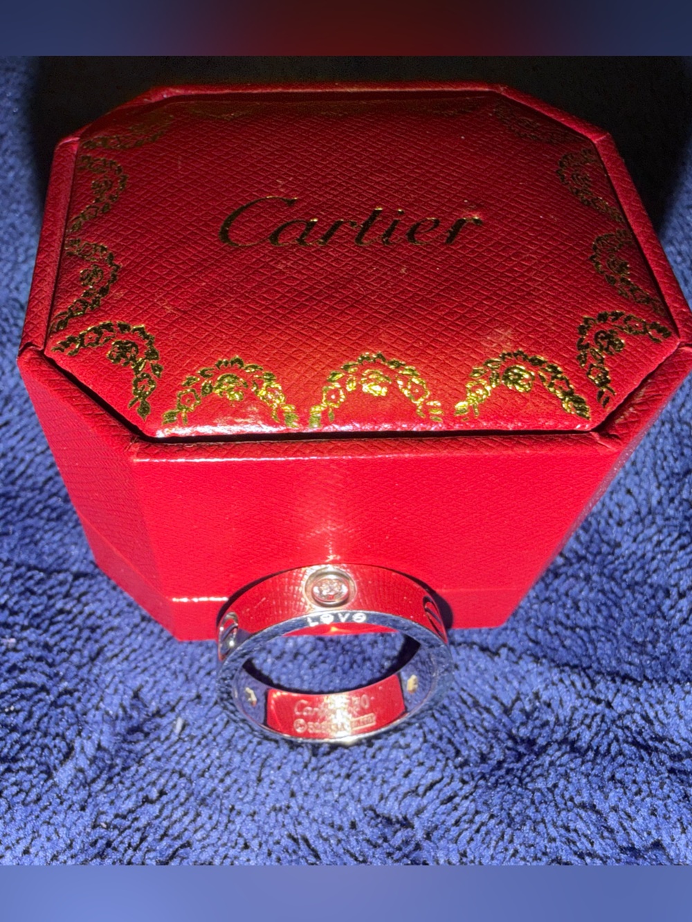 Cartier stylish Silver Tone Love Ring in a Red Jewelry Box.